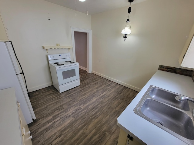 kitchen featuring sink, white appliances, dark wood-type flooring, white cabinetry, and hanging light fixtures