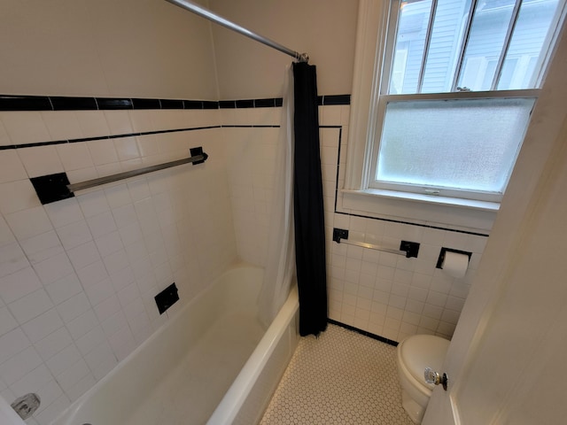 bathroom featuring tile walls, tile patterned floors, toilet, and shower / tub combo with curtain