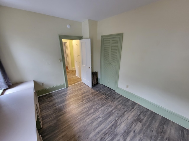 empty room with dark wood-type flooring