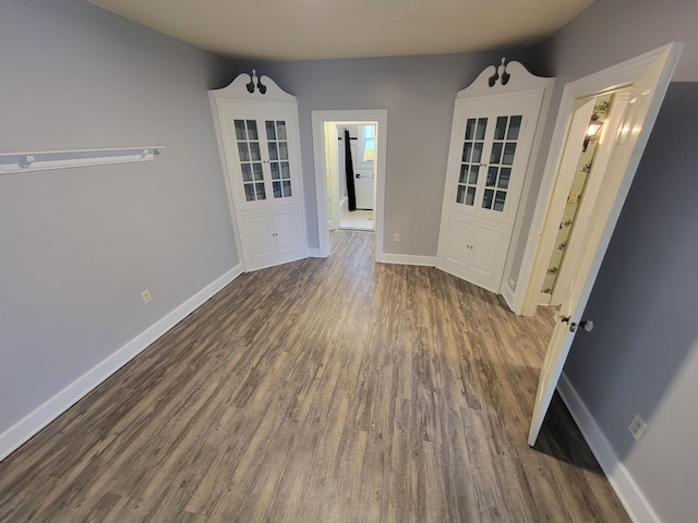 empty room with dark hardwood / wood-style flooring