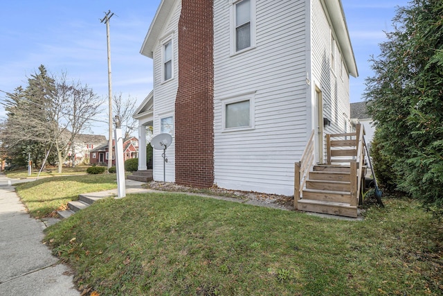 view of side of property featuring a yard