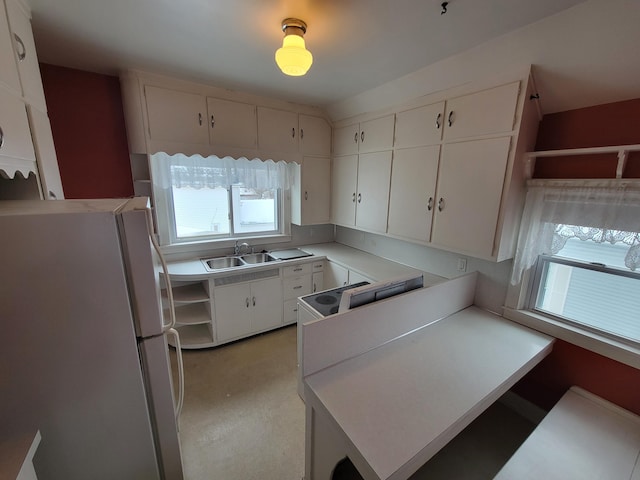 kitchen with white cabinetry, sink, white appliances, and kitchen peninsula