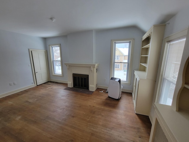 unfurnished living room with dark hardwood / wood-style flooring