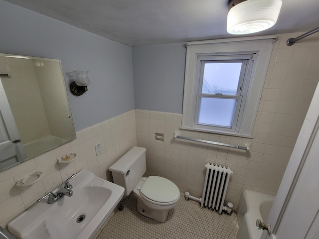 bathroom featuring radiator heating unit, sink, tile walls, tile patterned flooring, and toilet