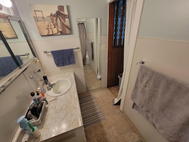 bathroom featuring tile patterned flooring and vanity