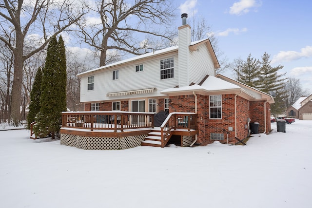 snow covered property featuring a wooden deck