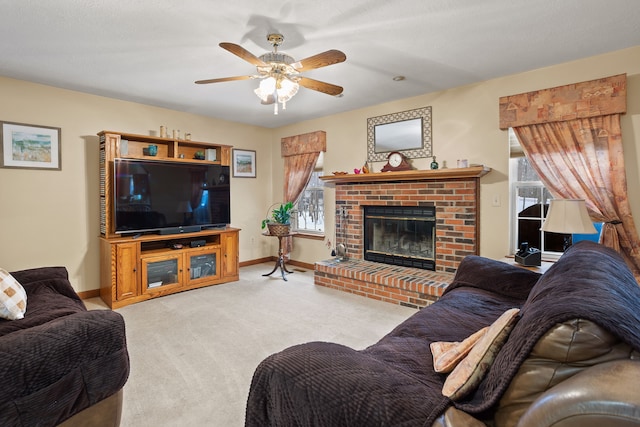 living room featuring ceiling fan, a fireplace, and light carpet