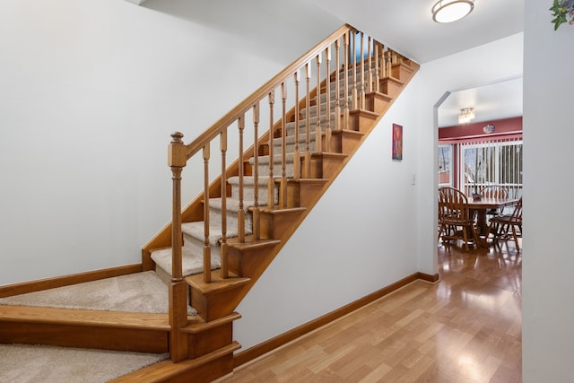 stairway with hardwood / wood-style floors