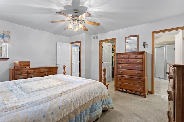 carpeted bedroom featuring ceiling fan, a walk in closet, and a closet