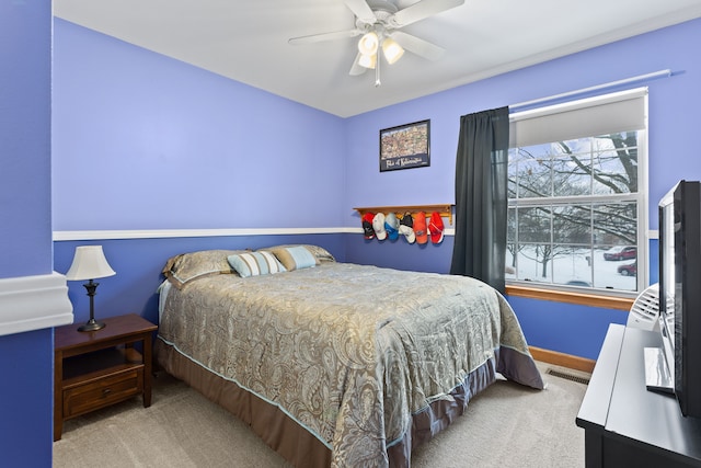 bedroom with light colored carpet and ceiling fan