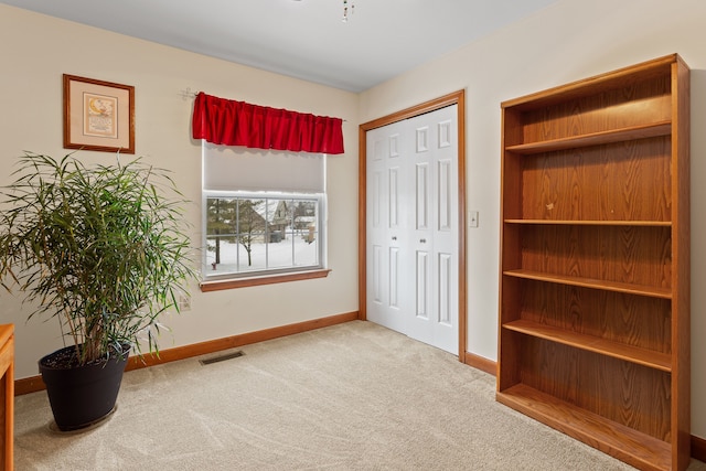 carpeted bedroom with a closet