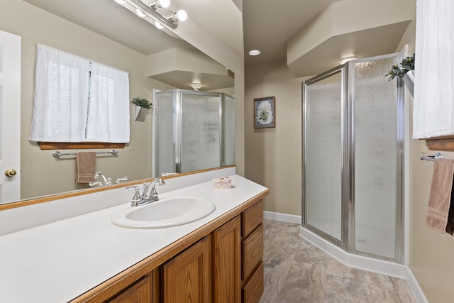 bathroom featuring vanity and a shower with shower door