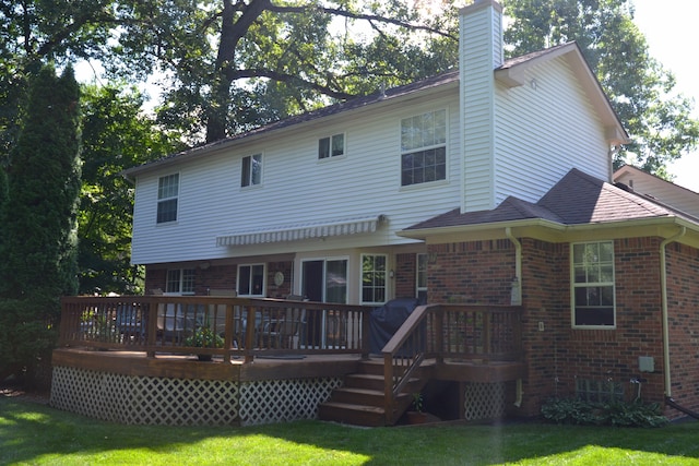 rear view of property featuring a wooden deck