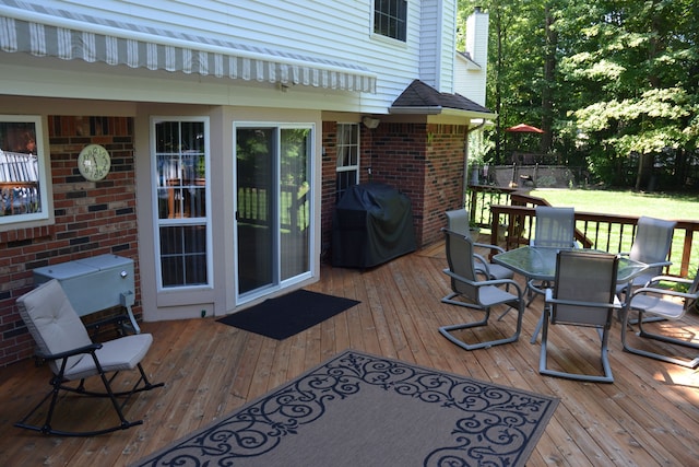 wooden deck featuring area for grilling