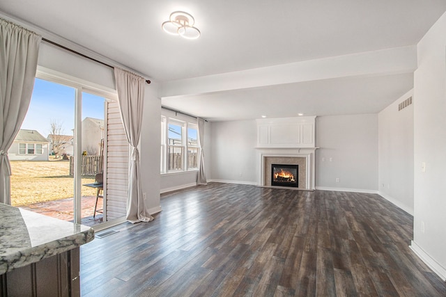 unfurnished living room featuring dark hardwood / wood-style floors