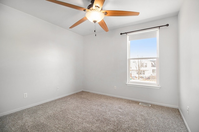 empty room featuring ceiling fan and carpet floors