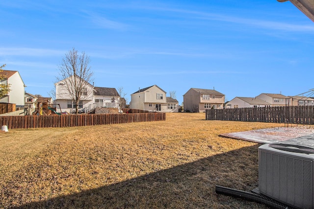 view of yard featuring a playground and central AC