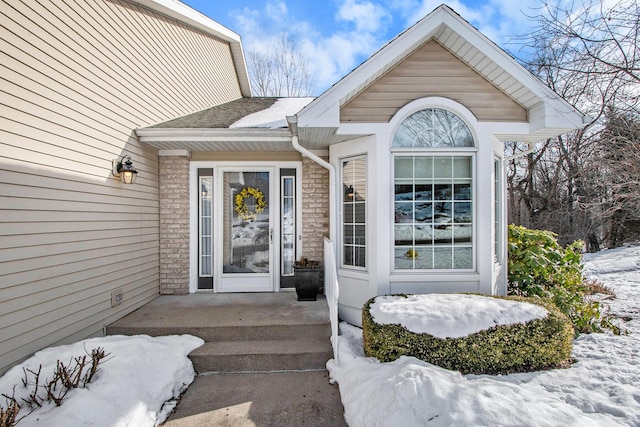 view of snow covered property entrance