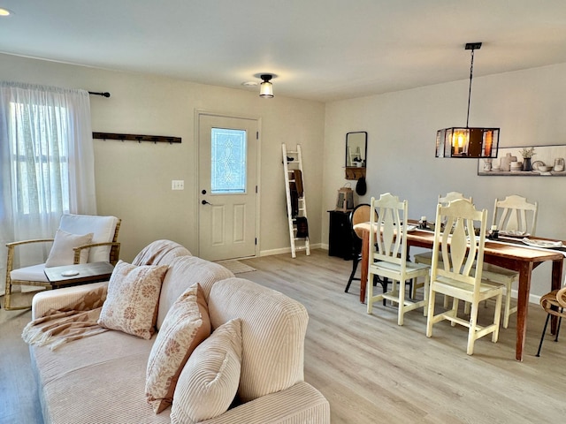 living room featuring light wood-type flooring and a healthy amount of sunlight