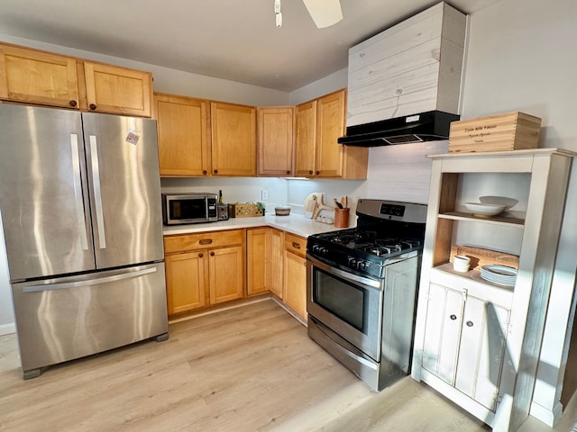 kitchen with extractor fan, appliances with stainless steel finishes, light brown cabinets, and light hardwood / wood-style floors