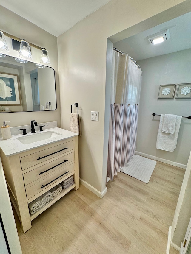 bathroom featuring vanity and wood-type flooring