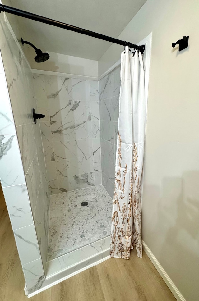 bathroom featuring hardwood / wood-style floors and curtained shower