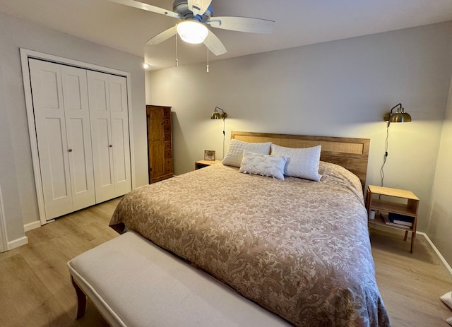 bedroom featuring hardwood / wood-style flooring, ceiling fan, and a closet