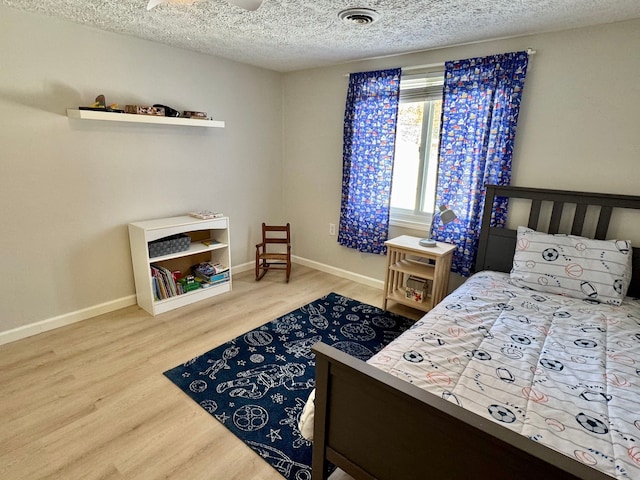 bedroom featuring a textured ceiling and hardwood / wood-style floors