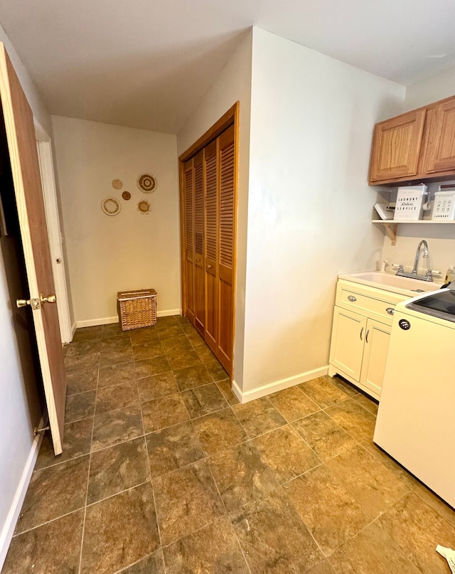 kitchen featuring sink and washer / dryer