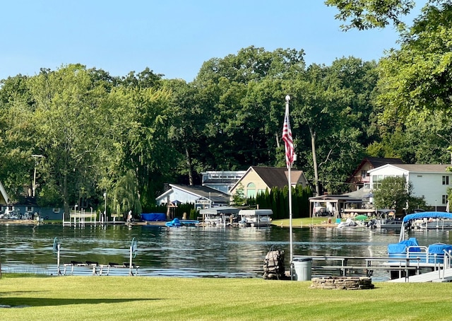 view of community with a lawn and a water view