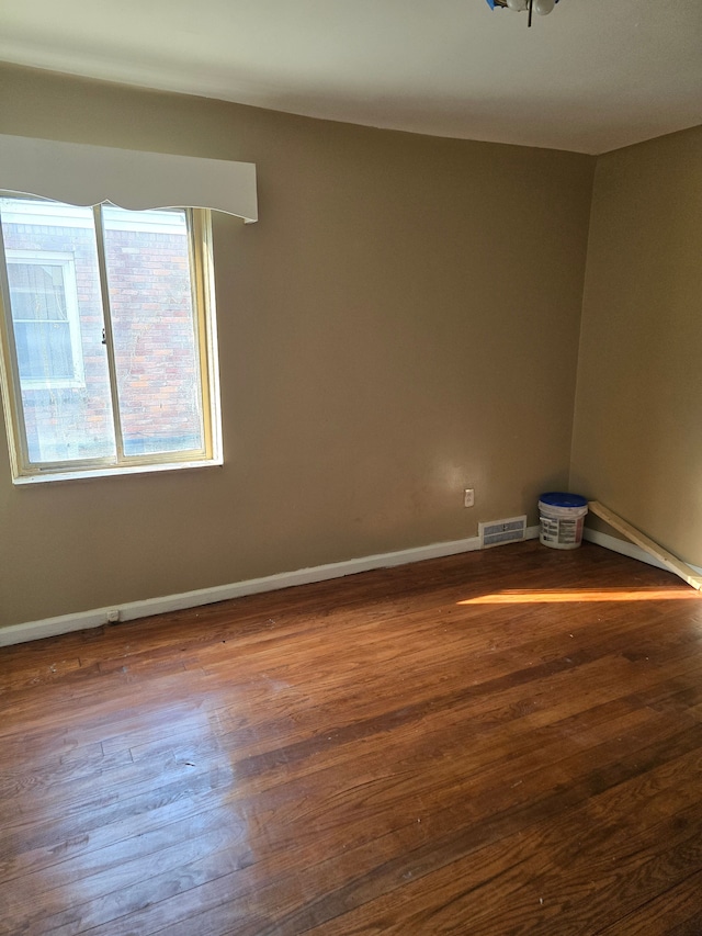 unfurnished room featuring hardwood / wood-style flooring