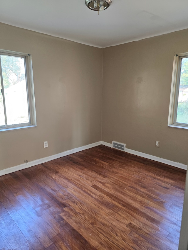 spare room featuring dark hardwood / wood-style floors