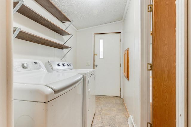 laundry area featuring washer and dryer and a textured ceiling