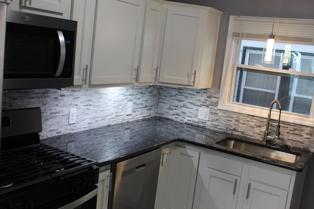 kitchen with sink, black gas stove, white cabinetry, decorative backsplash, and stainless steel dishwasher