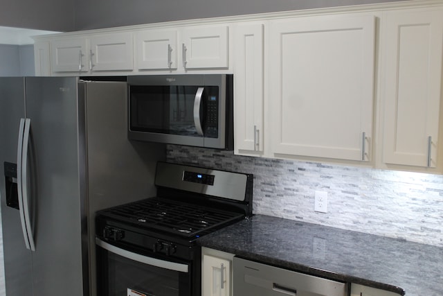 kitchen featuring stainless steel appliances, white cabinetry, and tasteful backsplash