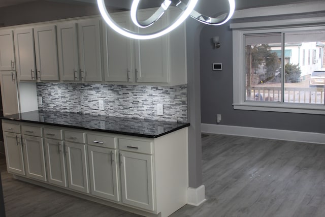 kitchen featuring white cabinetry, dark wood-type flooring, and decorative backsplash