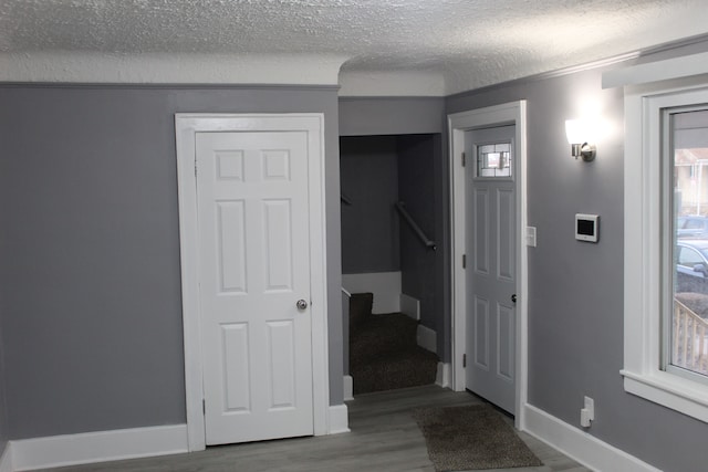 interior space with wood-type flooring and a textured ceiling