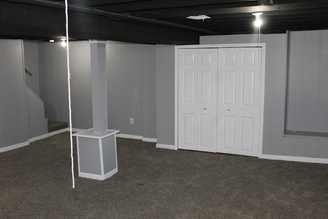 basement featuring dark colored carpet