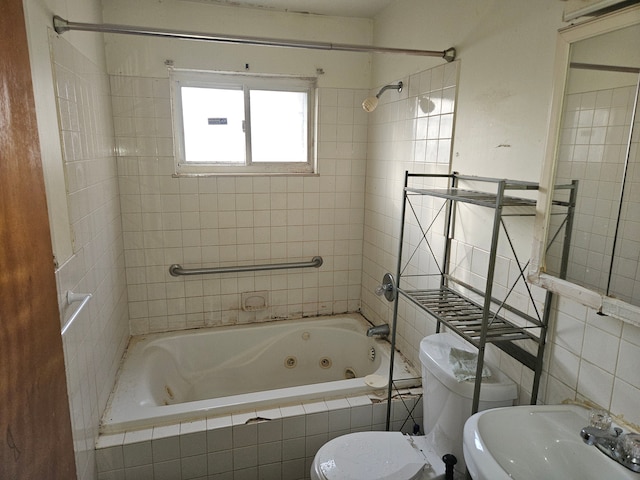 full bathroom with tiled shower / bath, sink, tile walls, and toilet