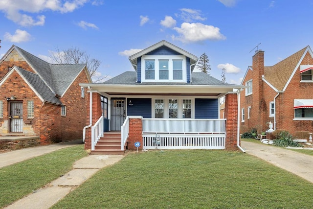 bungalow featuring a front yard and covered porch