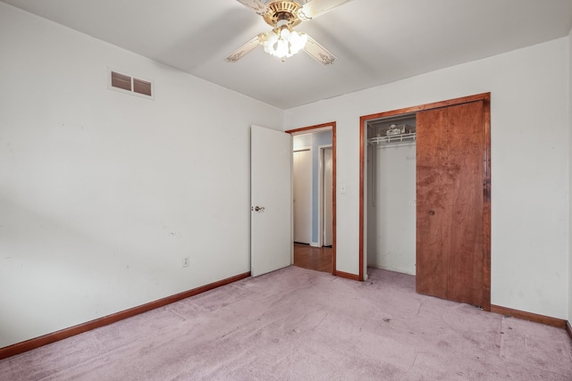 unfurnished bedroom featuring ceiling fan, a closet, and light carpet