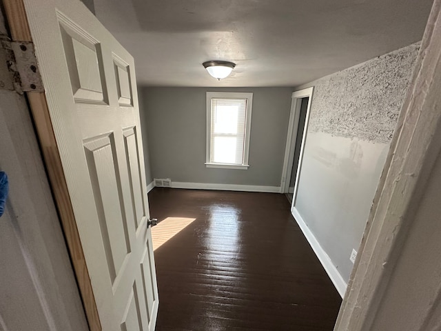 hallway with dark hardwood / wood-style floors