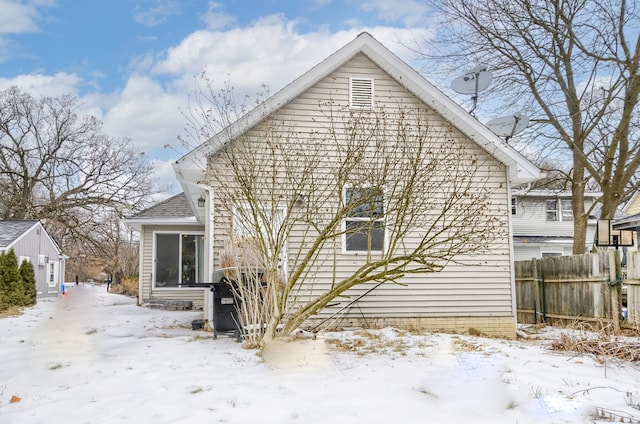 view of snow covered back of property