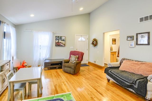 interior space with high vaulted ceiling and light wood-type flooring