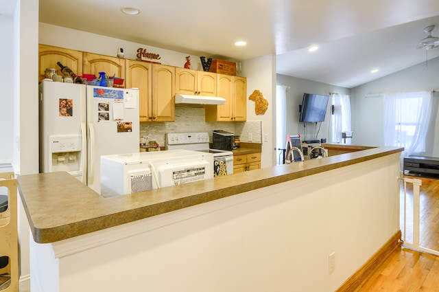 kitchen featuring light brown cabinetry, tasteful backsplash, vaulted ceiling, light hardwood / wood-style flooring, and white appliances