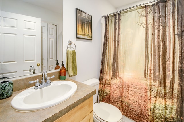 bathroom featuring vanity and toilet