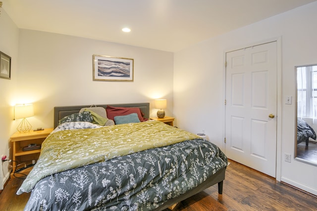 bedroom with dark wood-type flooring