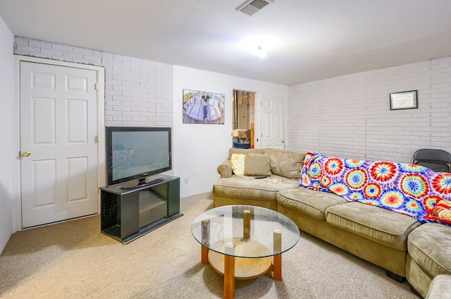 living room featuring brick wall