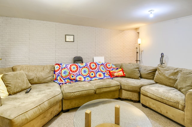 living room with light colored carpet and brick wall