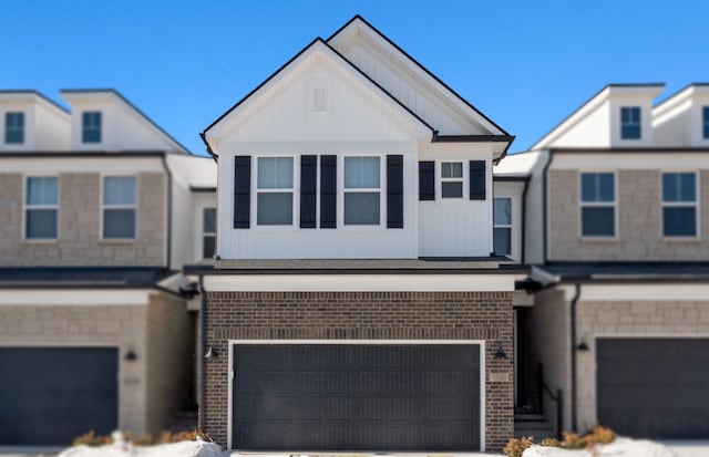 multi unit property with brick siding, concrete driveway, and a garage